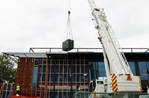 Packaged plant room being lifted into position (Prefabricated plant room).