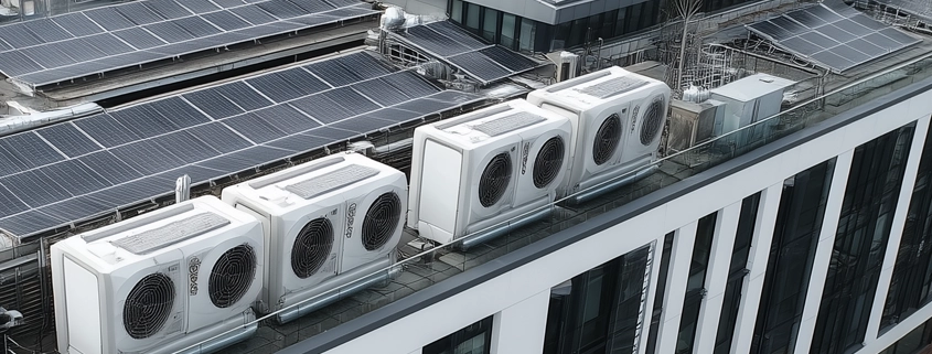 pv array and heat pumps on the roof of a commercial build;ing